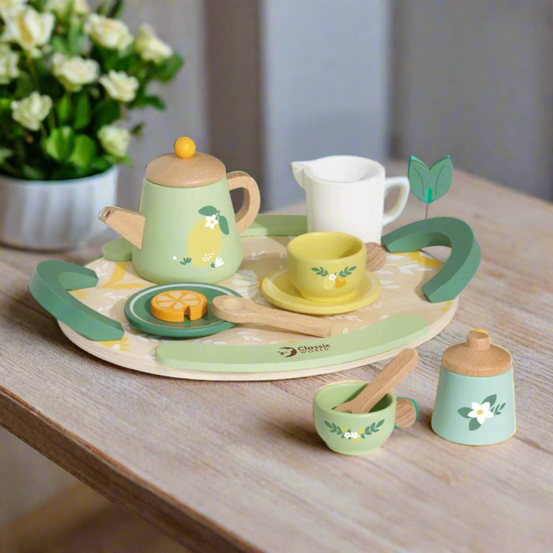 Children's wooden tea set with green and yellow colors on a white background